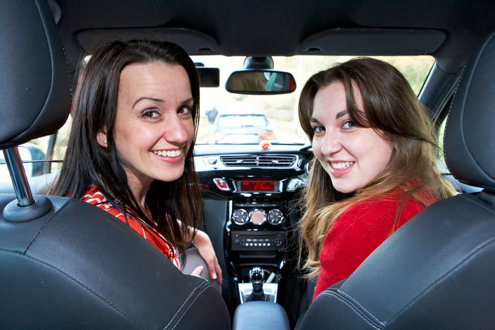 Instructor and driver smiling during a refresher driving lesson